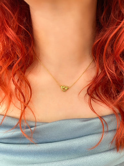 Bridesmaid wearing 18kt Gold plated sterling silver heart knot necklace 