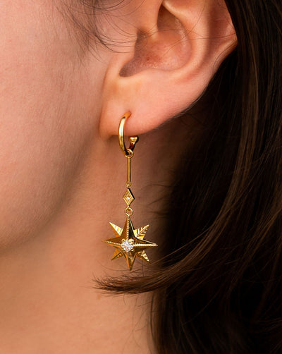 Model wearing statement gold bar star drop hoop earring with CZ crystals
