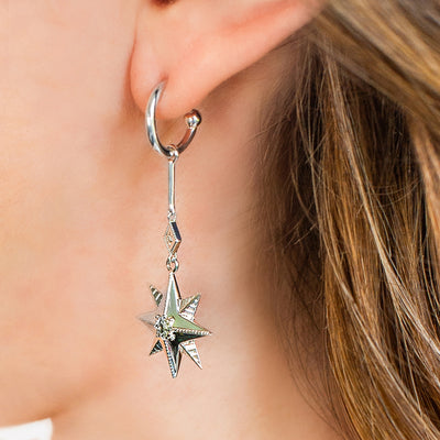Model wearing statement sterling silver bar star drop hoop earrings with CZ crystals