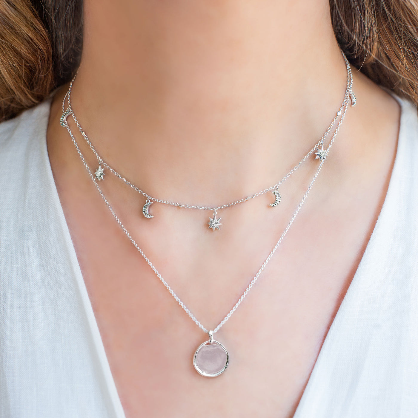Model wearing sterling silver moon and star choker necklace with CZ crystals and silver coin necklace