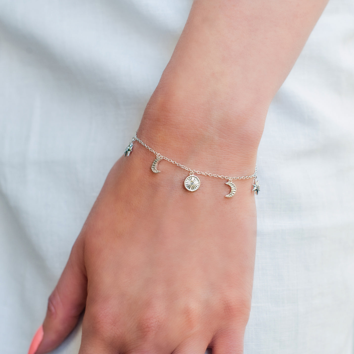 Model wearing sterling Silver moon and star charm bracelet with CZ crystals