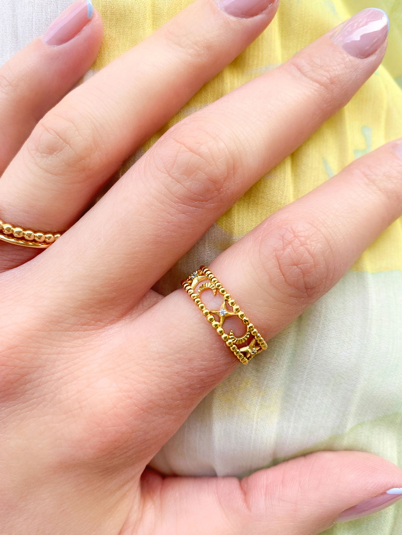Model wearing gold moon and star filigree ring with CZ crystals