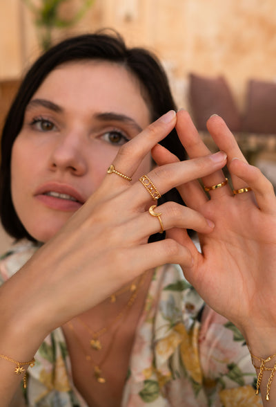 Model wearing gold plated sterling silver moon and star filigree ring with engraved moon and sun ring set 