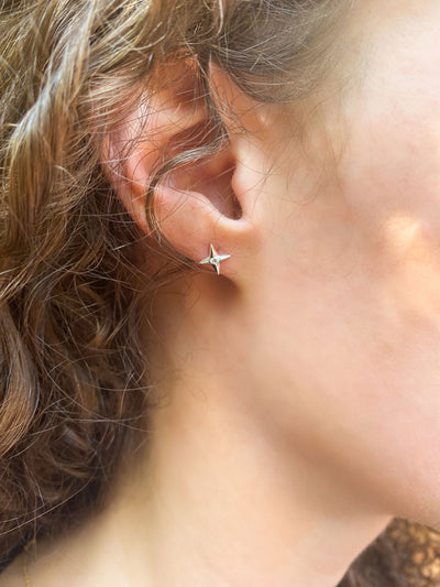 Model wearing silver star stud earring with CZ Crystals