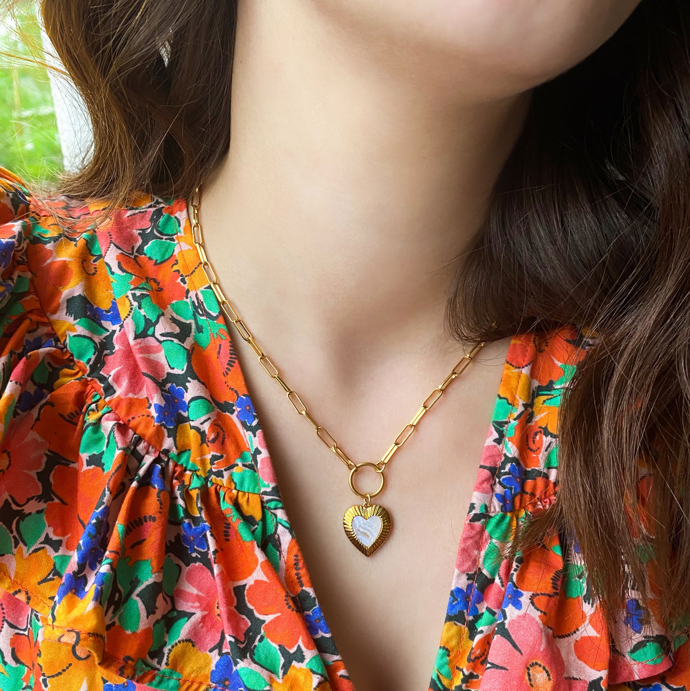 Model wearing chunky chain necklace with blue lace agate heart charm
