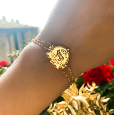 Model wearing gold plated sterling silver double chain bracelet featuring engraved tiger charm