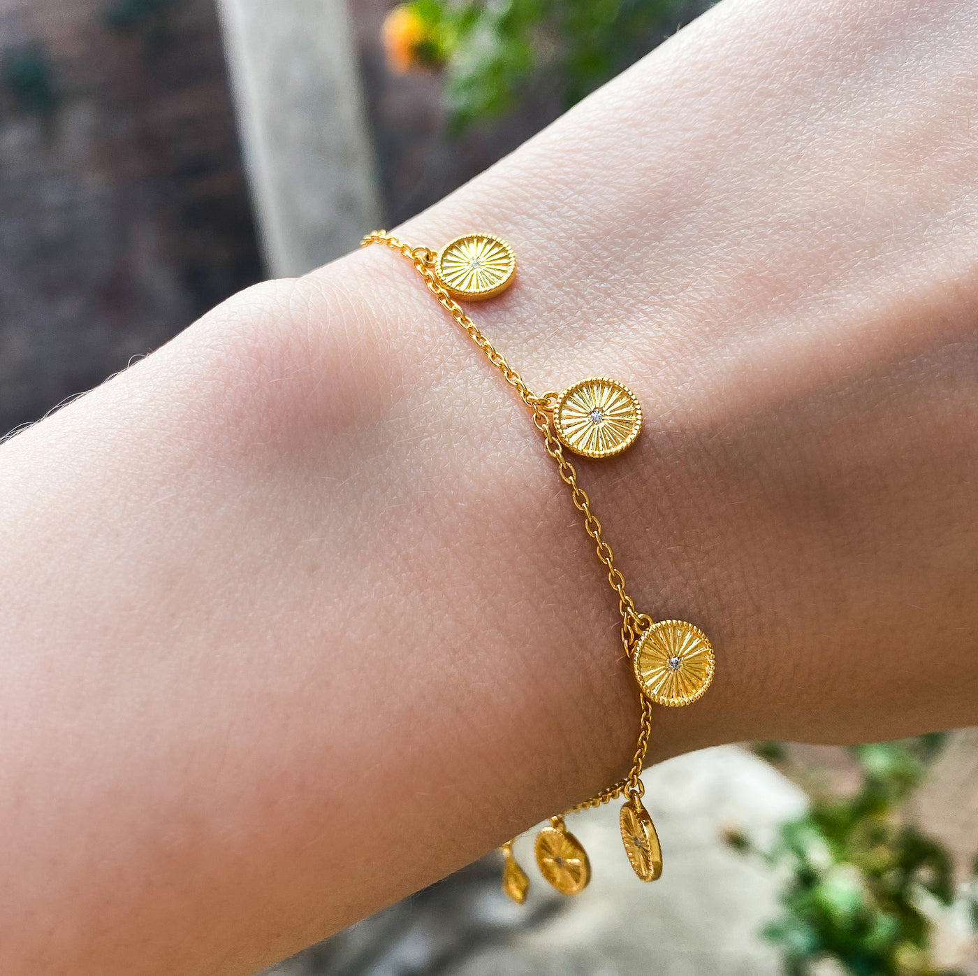 Gold plated sterling Silver bracelet with engraved coin hanging charms featuring CZ crystals