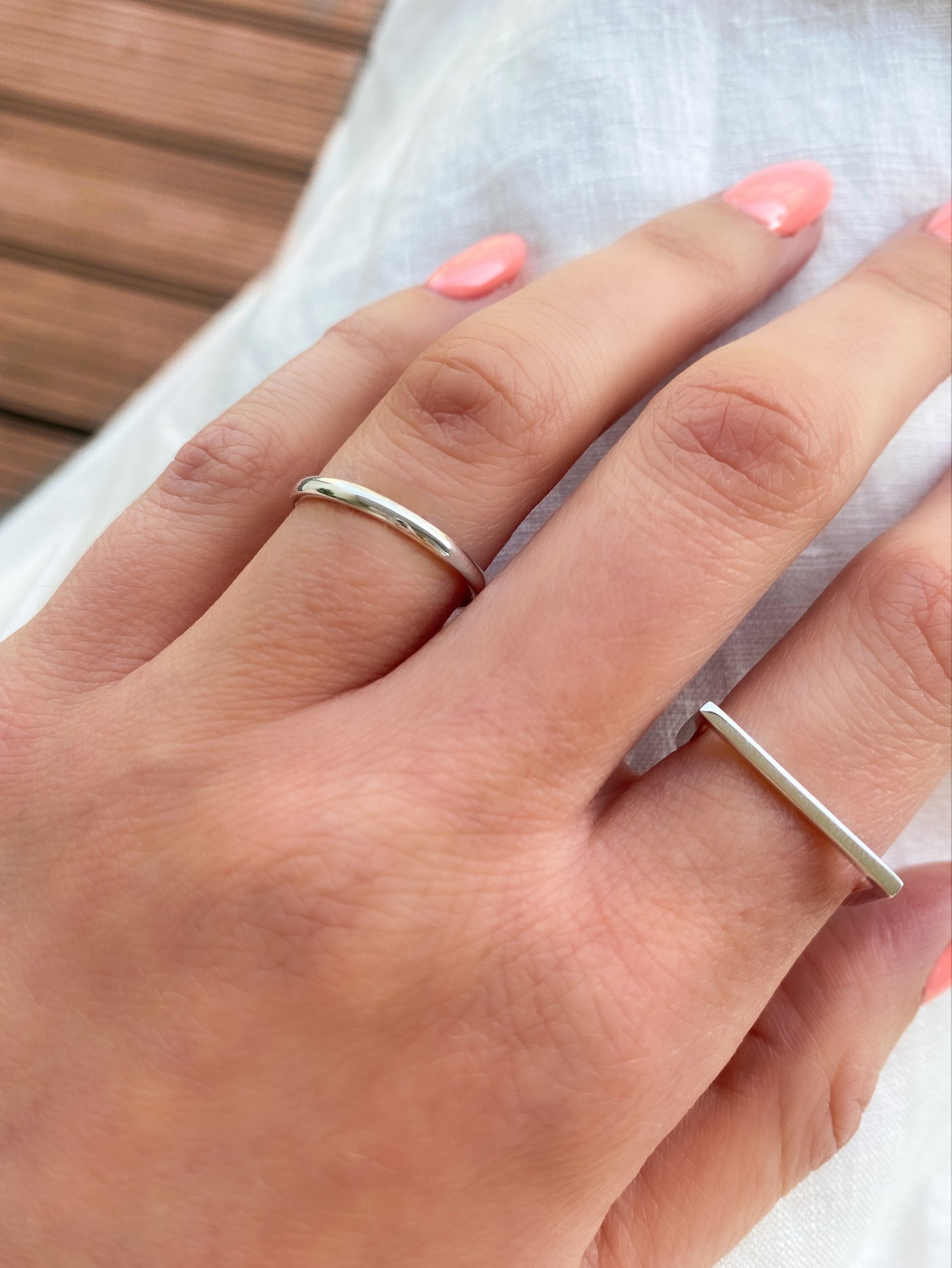 Model wearing sterling silver minimal ring with simple, plain ring band
