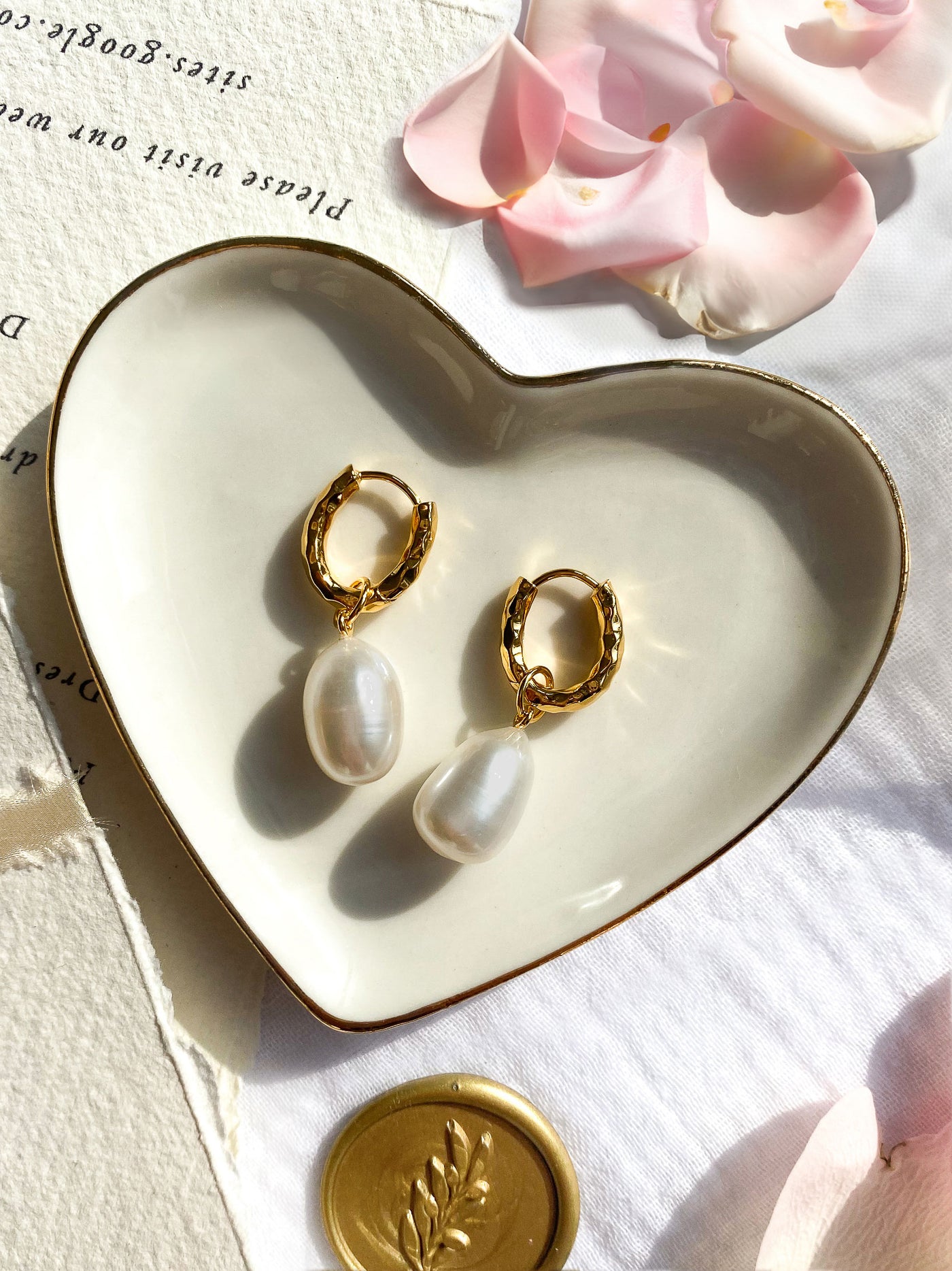 Gold plated sterling silver textured hoop drop earrings featuring freshwater pearls in heart dish