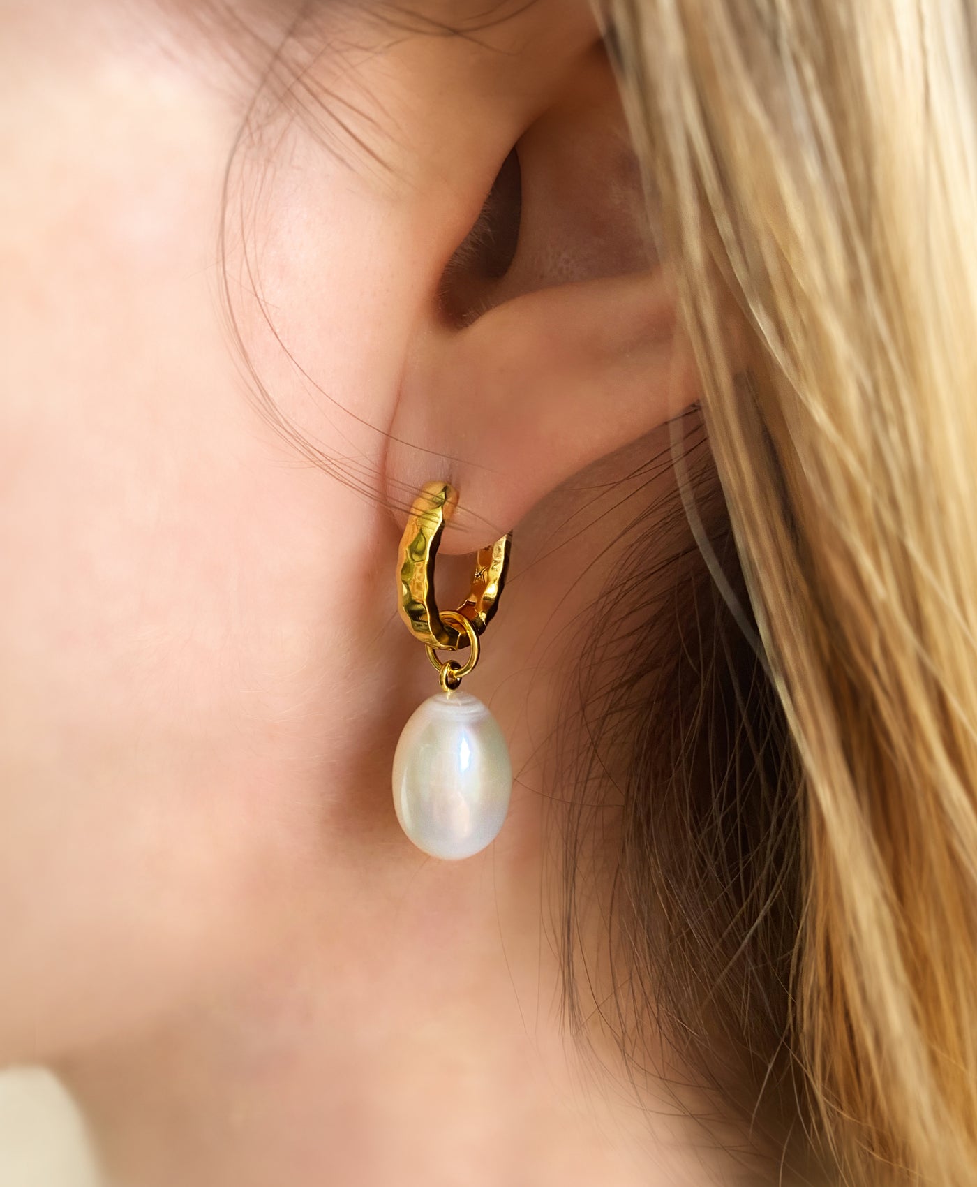 Model wearing bridal gold plated sterling silver textured hoop drop earrings featuring freshwater pearls