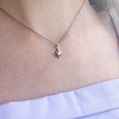 Model wearing sterling silver dainty star necklace with CZ crystal