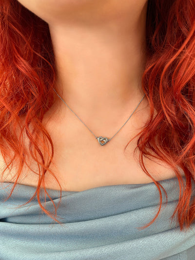 Bridesmaid wearing sterling silver heart knot bridesmaid necklace