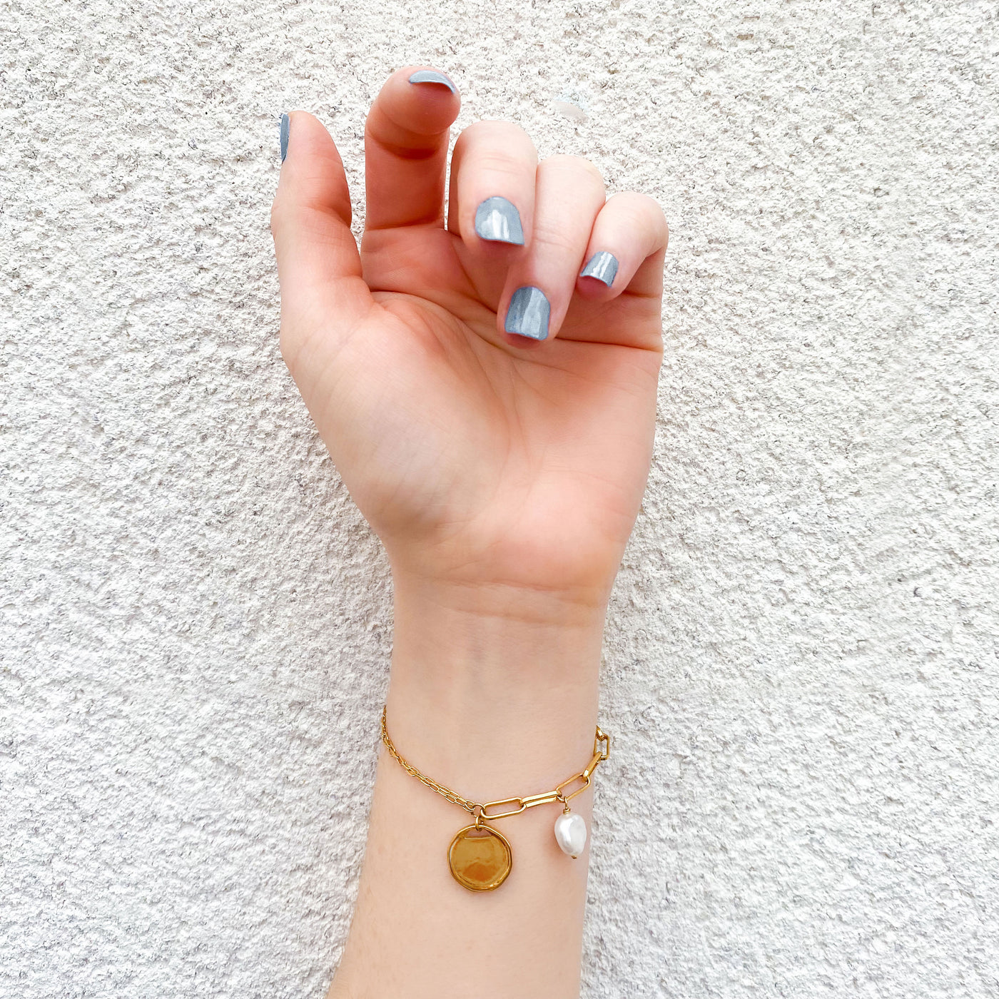 Model wearing gold plated sterling silver coin and freshwater pearl bracelet 